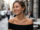 A woman wearing Yue TerraBrio blue gemstone and pearl jewelry in a soft everyday lifestyle setting.