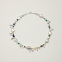 Studio display of the Yue TerraBrio multi-gemstone necklace featuring raw Lapis Lazuli pillars, Malachite discs, and sculptural Baroque pearls on 925 silver.