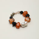 Yue TerraBrio Earthbound Sentinel bracelet with large Baroque pearls, Red Persian Agate, and Black Tourmaline for spiritual grounding.