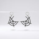 Nocturne Web black spinel beaded drop earrings with stainless steel hoop fittings on a cream background.