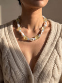 Model wearing the citrine, aquamarine, and baroque pearl necklace with a cream knit cardigan.