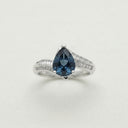 Yue TerraBrio Abyssal Wave adjustable ring with a pear-cut London blue topaz, cubic zirconia accents, and a 925 sterling silver wave band.