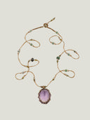 Flat lay of the temple-consecrated Amethyst Masterpiece Necklace by Yuè TerraBrio, featuring a faceted egg-shaped pendant and 47 sacred stones for path alignment.
