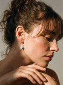 Yue TerraBrio azure echo larimar and seed pearl drop earrings on a female model for intuition and throat chakra healing.