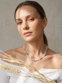 Yuè TerraBrio Azure Intuition necklace worn by a model in warm natural light, highlighting the luminous texture of lapis and clear quartz
