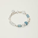 Yuè TerraBrio Azure Resonance bracelet featuring blue lapis barrel beads, faceted abacus stones, and crushed ice quartz with S925 silver.