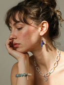 Yue TerraBrio lifestyle banner featuring pearl necklace, blue kyanite bracelet, and lapis lazuli earrings on a model.