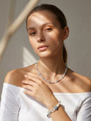 Yuè TerraBrio Azure Intuition jewelry set featuring lapis lazuli, quartz, and pearl necklace and bracelet on a white background.