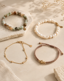 Natural gemstone, pearl, metal, and cord jewelry arranged for Yue TerraBrio care by material guide.