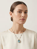 Professional model styling the Blue Topaz and 66-stone Duo Bao energy necklace, demonstrating the "Sculptural Minimalism" aesthetic for modern spiritual adornment.
