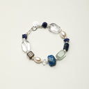 A temple-blessed energy bracelet featuring Lapis Lazuli, Smoky Quartz, and Green Quartz with a personalized S925 sterling silver engravable tag.
