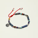 Yue TerraBrio Cosmic Nomad adjustable bracelet with lapis lazuli, turquoise, warm-toned mineral accents, textured silver details, and a sterling silver medallion.