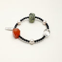 Yue TerraBrio Equilibrium Aura bracelet with Persian red agate, raw prehnite, clear quartz, faceted black tourmaline, freshwater pearls, and a sterling silver logo tag.