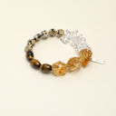 Yue TerraBrio Golden Terrain bracelet with Brazilian freeform citrine, yellow tiger eye rice beads, clear quartz tusk beads, spotted round disc beads, and a sterling silver logo tag.
