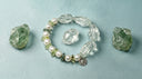 Yue TerraBrio green quartz and pearl bracelet displayed with raw green stones, representing natural gemstones, symbolic meaning, and personal intention.