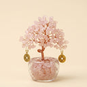 Yue TerraBrio Harmonic Bloom rose quartz crystal tree with hand-twisted copper wire, clear glass pot, and tumbled stone base.