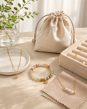 Natural gemstone bracelet, pearl jewelry, soft pouch, and care cloth for Yue TerraBrio jewelry care.