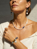 Woman wearing Yue TerraBrio necklace and bracelet with beads, against a neutral background.