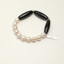 Yue TerraBrio Midnight Poise bracelet with black agate barrel beads, freshwater pearls, Thai silver spacer beads, and a sterling silver logo tag.