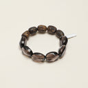 Yue TerraBrio Primal Stillness bracelet with smoky quartz beads, agarwood beads, and a sterling silver bar charm.