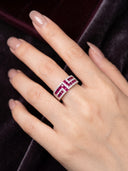Model wearing the Yue TerraBrio Ruby Poise adjustable sterling silver ring with ruby and zircon accents on a dark velvet background.