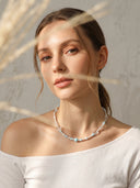 Yue TerraBrio Serene Azure healing necklace on a female model with larimar, seed pearls, and clear quartz for throat chakra.