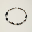 Yuè TerraBrio Shadow & Light necklace featuring smoky quartz tusks, black tourmaline chips, and black agate cubes with a 925 silver T-clasp.