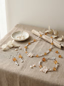 Yue Terrabrio Jewelry set including necklace, bracelet, and earrings on a textured surface with a neutral background.