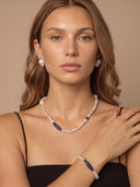 Model wearing the Yue TerraBrio Stellar Horizon lapis lazuli and pearl bracelet with the matching baroque pearl and Afghan lapis lazuli necklace.