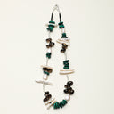 A temple-consecrated energy necklace featuring Smoky Quartz, Malachite, and Black Tourmaline with sculptural Baroque pearls and sterling silver curved tubes.