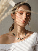 Yue TerraBrio Verdant Ascent necklace on a female model with Thousand-Layer Phantom Quartz, Moss Agate, and seed pearls.