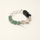 Yue TerraBrio Verdant Poise bracelet with large black agate cube beads, green aventurine beads, clear rhomboid beads, baroque waterdrop pearls, and a sterling silver logo tag.