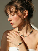 Yue TerraBrio Verdant Pulse bracelet on a female model with natural Moss Agate, Seed Pearls, and 925 sterling silver architectural tubes.