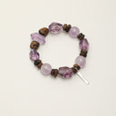 Yue TerraBrio Violet Stillness bracelet with amethyst double points, freeform amethyst, amethyst round beads, agarwood beads, sterling silver spacer beads, and a sterling silver logo tag.