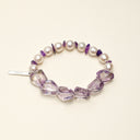 Yue TerraBrio Violet Stillness bracelet with freeform amethyst, amethyst chips, spiral-textured pearl beads, and a sterling silver logo tag.